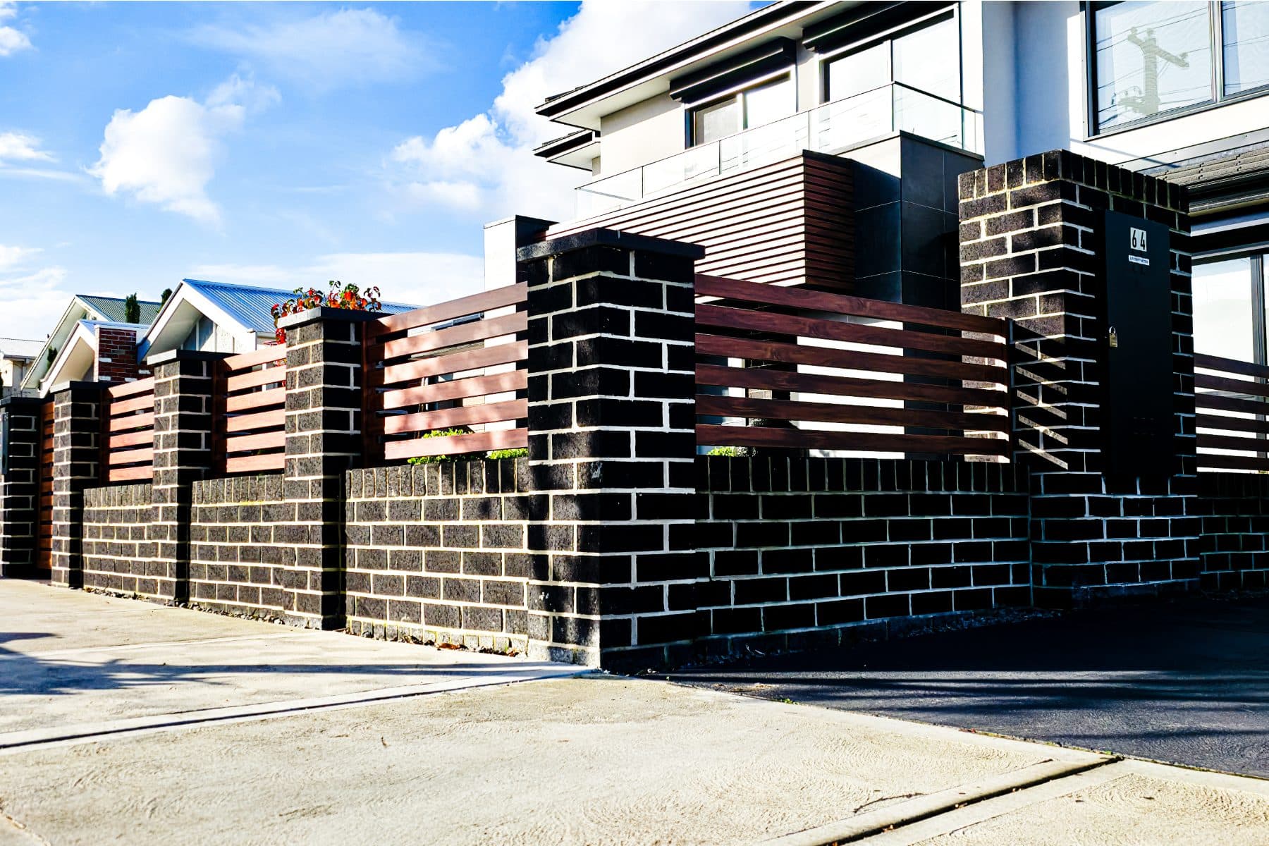 Charcoal brick fence on corner of new home